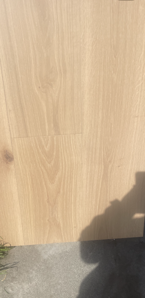 "Photograph of a light, raw natural oak wood floor, showcasing its subtle grain patterns and natural elegance."